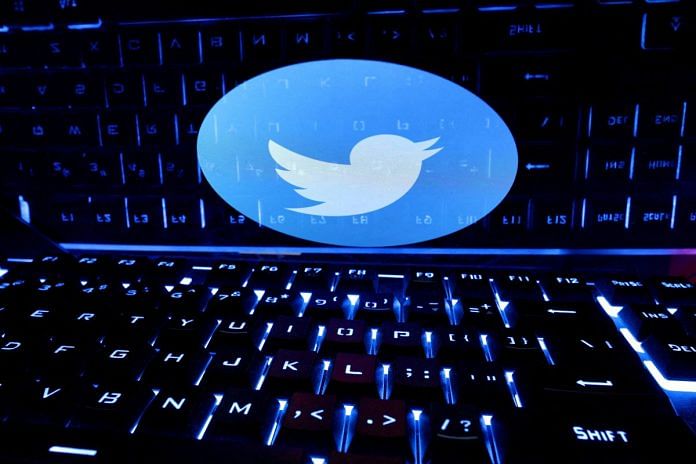 A keyboard is placed in front of a displayed Twitter logo in this illustration | Reuters