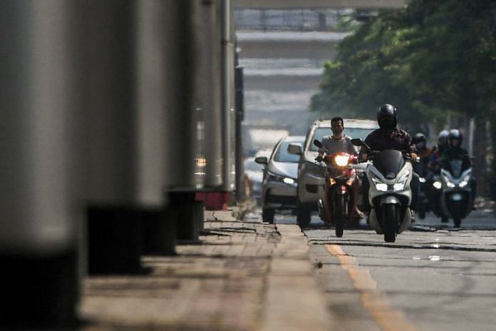 Motorbike riders are seen through heat haze as temperatures hit a record 45.4 degrees Celsius (113.7 Fahrenheit) in Bangkok, Thailand, on 21 April 2023 | Reuters