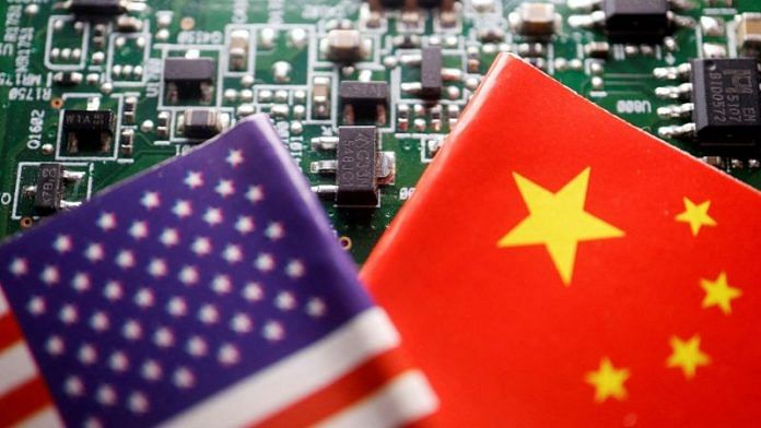 Flags of China and U.S. are displayed on a printed circuit board with semiconductor chips, in this illustration picture | Reuters