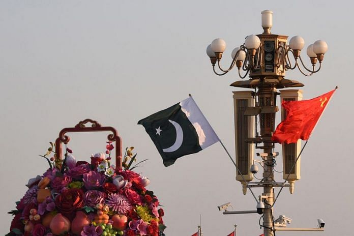 Pakistani and Chinese national flags flutter next to an installation featuring a giant flower basket at the Tiananmen Square in Beijing | Reuters File Photo