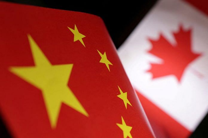 Printed Chinese and Canada flags are seen in this illustration | Reuters