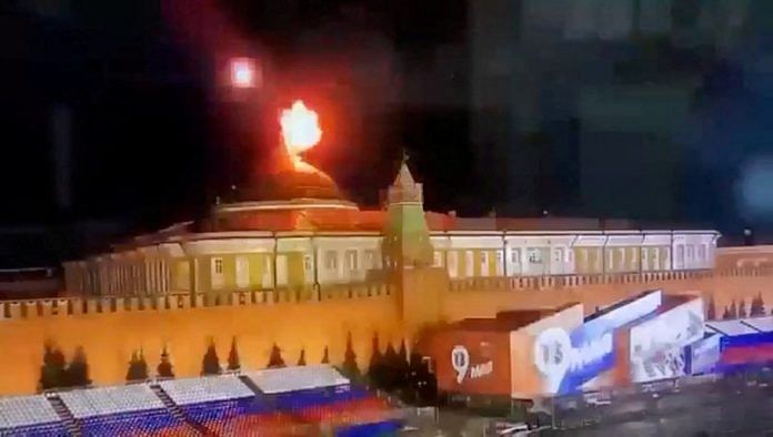 A still image taken from video shows a flying object exploding in an intense burst of light near the dome of the Kremlin Senate building during the alleged Ukrainian drone attack in Moscow, on 3 May 2023 | Ostorozhno Novosti/Handout via Reuters