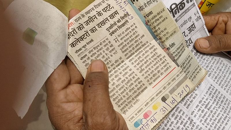 A priest travels with newspaper clippings on the temple ownership issue | Photo: Shubhangi Misra, ThePrint