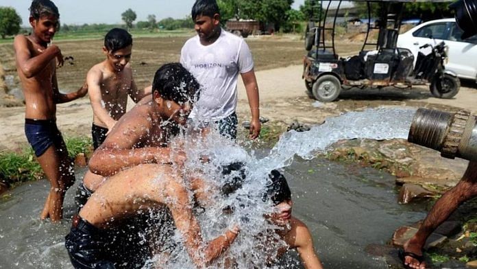 File photo of a group of Delhi residents splashing water on themselves during a heatwave | Photo: Suraj Singh Bisht | ThePrint