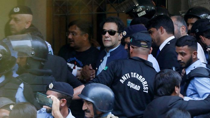 Security officers escort Pakistan's former Prime Minister Imran Khan, as he appeared in Islamabad High Court, on 12 May 2023 | Reuters