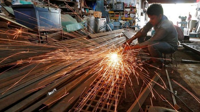 A worker grinds a metal gate inside a household furniture manufacturing factory in Ahmedabad | File Photo: Reuters