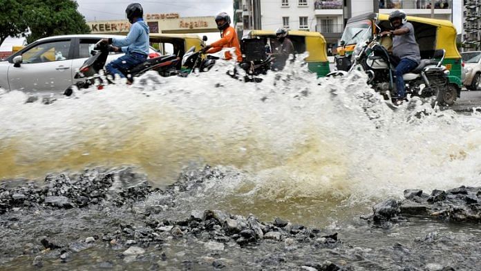 Traffic moves as water is pumped out of an inundated residential area following torrential rains in Bengaluru | File Photo: Reuters