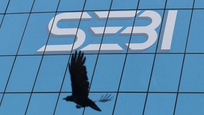 A bird flies past the new logo of the Securities and Exchange Board of India (SEBI) at its headquarters in Mumbai | File Photo: Reuters