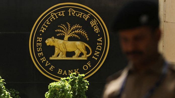 A police officer walks past the Reserve Bank of India (RBI) logo inside its headquarters in Mumbai | File Photo: Reuters