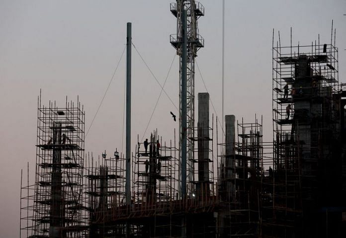 Labourers work at the construction site of a commercial building in New Delhi | Reuters