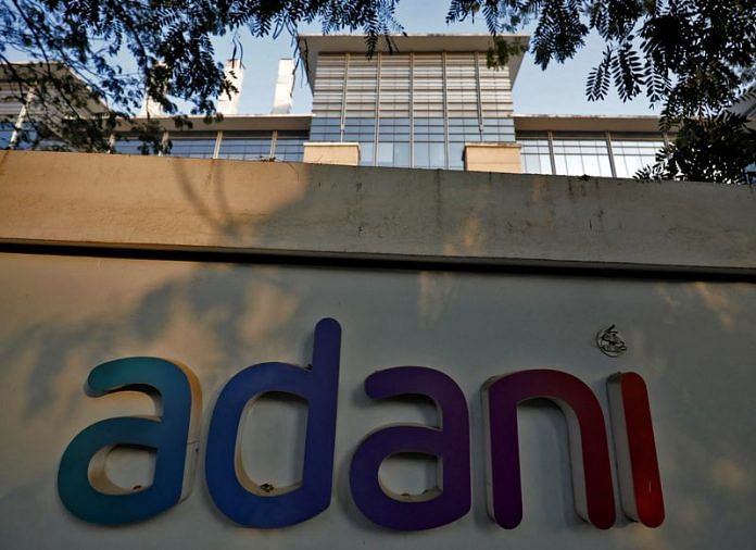 The logo of the Adani Group is seen on the wall of its realty office building on the outskirts of Ahmedabad, India | Photo: Reuters File