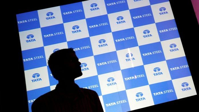 A man walks past a screen displaying Tata Steel logo before the start of a news conference in Mumbai | File Photo: Reuters