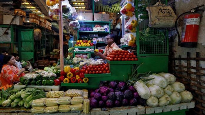 A vendor sells vegetables at a retail market in Kolkata | File Photo: Reuters