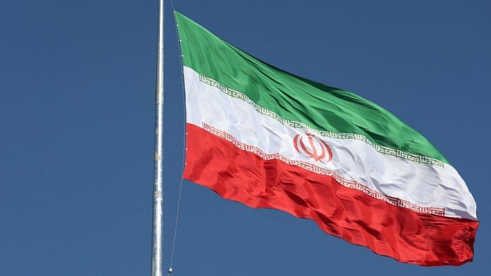 The Iranian flag is seen flying over a street in Tehran | Majid Asgaripour/WANA (West Asia News Agency) via Reuters