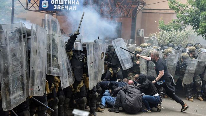 NATO Kosovo Force (KFOR) soldiers clash with local Kosovo Serb protesters at the entrance of the municipality office, in the town of Zvecan, Kosovo, on 29 May 2023 | Reuters/Laura Hasani