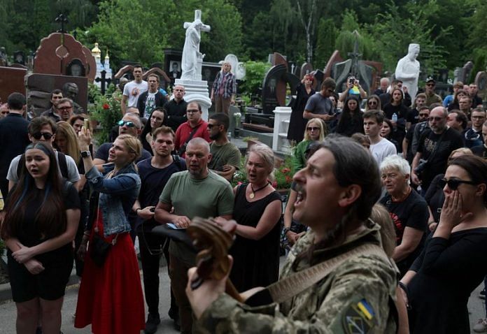 Friends, family, fellow soldiers and others honor soldier Roman Ratushnyi, a well-known activist, during his burial service in Kyiv on June 2022 | Reuters file photo