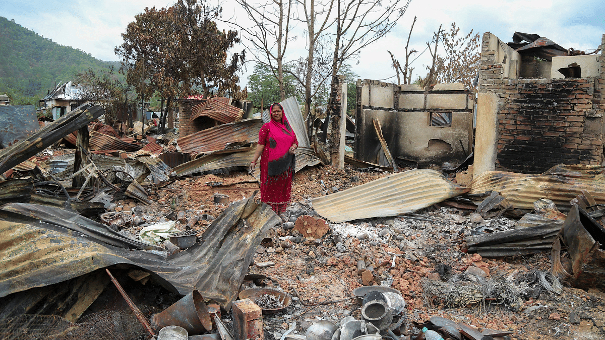 A resident of Ekou village at her shop that was burnt down by a mob | Suraj Singh Bisht | ThePrint