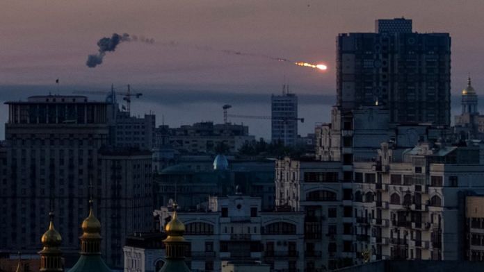An explosion of a missile is seen in the sky over the city during a Russian missile strike in Kyiv, on 18 May 2023 | Reuters