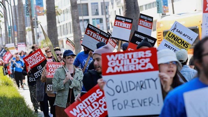 Workers and supporters of the Writers Guild of America protest outside the Netflix offices after union negotiators called a strike for film and television writers in Los Angeles, California on 2 May, 2023 | Reuters