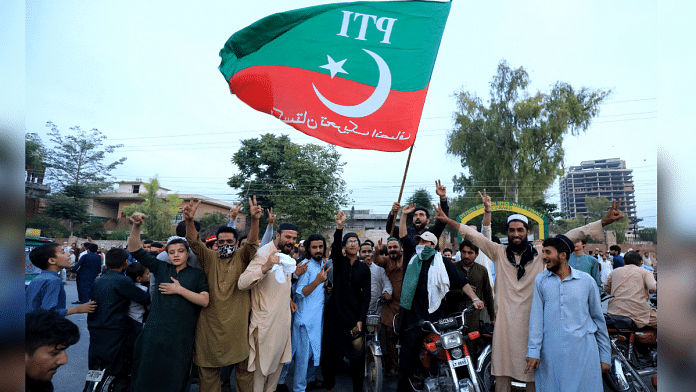 Imran Khan’s supporters shout slogans as they celebrate after the Supreme Court ruled that his arrest was illegal | Reuters