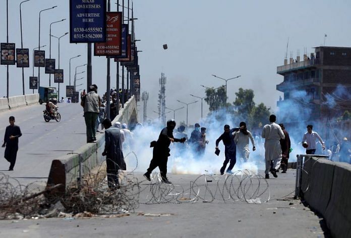 Supporters of Pakistan's former PM Imran Khan throw stones towards police during a protest in Peshawar | Reuters