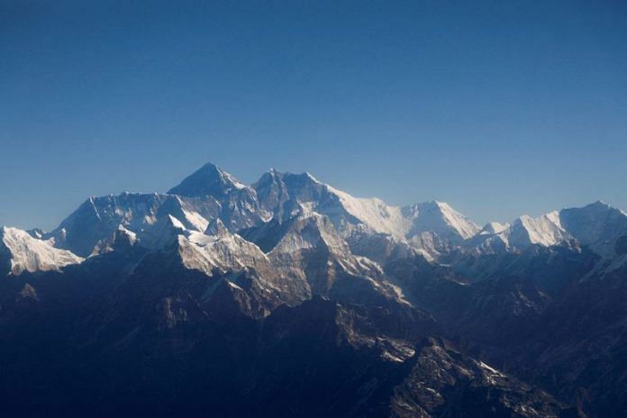 Mount Everest, the world's highest peak, and other peaks of the Himalayan range are seen through an aircraft window during a mountain flight from Kathmandu | Reuters