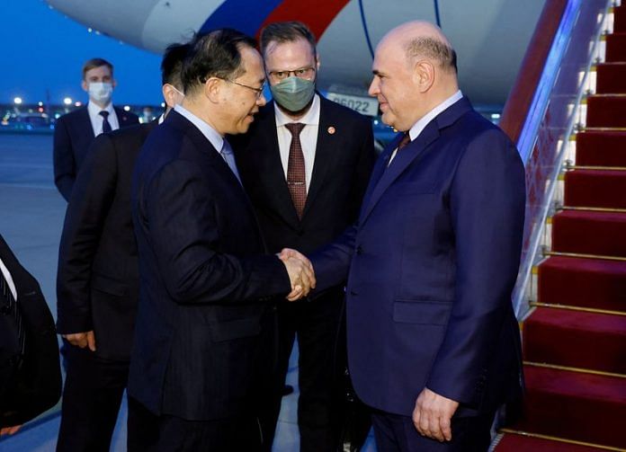 Russian PM Mikhail Mishustin shakes hands with Chinese Vice Foreign Minister Ma Zhaoxu upon his arrival in Beijing, China, on 23 May 2023 | Sputnik/Dmitry Astakhov/Pool via Reuters