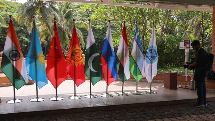 A video journalist films flags of countries participating in the SCO foreign ministers’ meeting, outside the venue in Goa | Reuters file photo/Francis Mascarenhas
