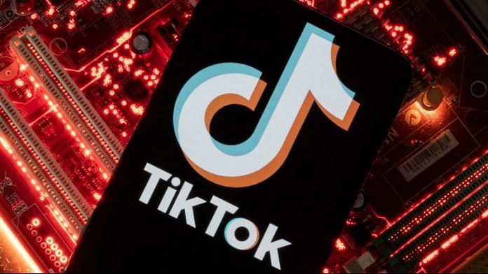 A smartphone with a displayed TikTok logo is placed on a computer motherboard in this illustration | Reuters