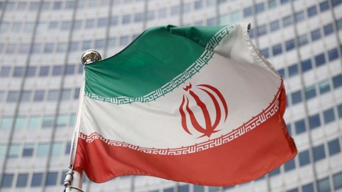 The Iranian flag waves in front of the International Atomic Energy Agency (IAEA) headquarters in Vienna, Austria | File Photo: Reuters
