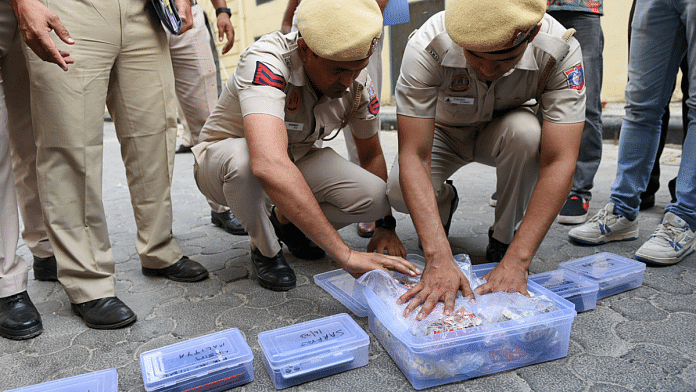 File photo of police with SIM cards recovered after busting a fake call center syndicate | ANI