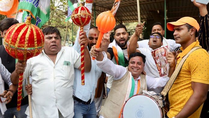 Party workers celebrate at the Congress headquarters in New Delhi | ThePrint photo by Manisha Mondal
