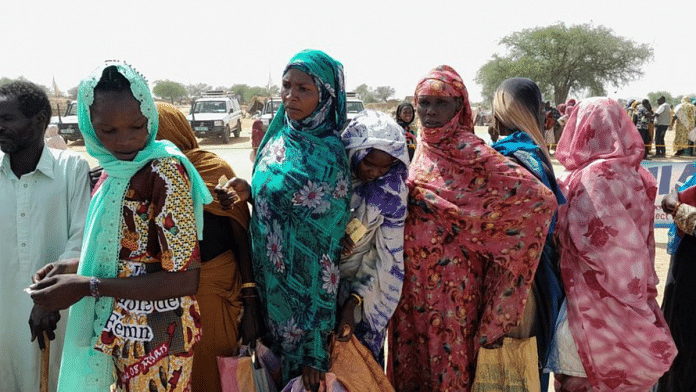 Sudanese refugees who have fled the violence in their country gather to receive food supplements from WFP, near the border between Sudan and Chad, in Koufroun, Chad | Reuters