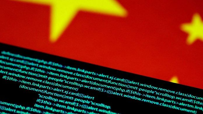 Computer code is seen on a screen above a Chinese flag | Reuters/Thomas White/Illustration//File Photo