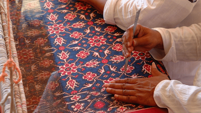 Textile artists demonstrate double ikat weaving. (Photo Credit-Flickr)