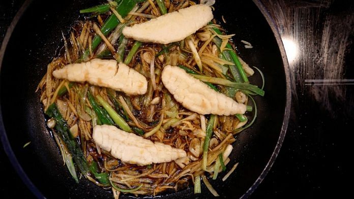 A dish containing pieces of 3D-printed cultivated grouper fish is prepared for a tasting at the offices of Steakholder Foods in Rehovot, Israel | Reuters/Amir Cohen