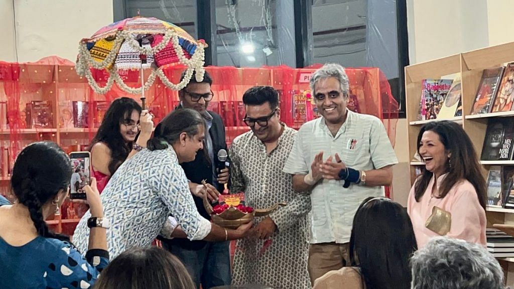 Yash, author Rasika Bhatia (far right)’s husband and co-wedding planner, launching the book (in a golden orb) on a makeshift mandap. | Humra Laeeq/ThePrint