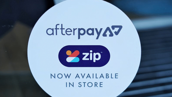 A logo for the companies Afterpay and Zip is seen in a store window in Sydney, Australia | Reuters
