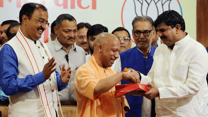 Chief Minister Yogi Adityanath celebrates party's victory in civic body polls at state BJP headquarters in Lucknow on Saturday | ANI