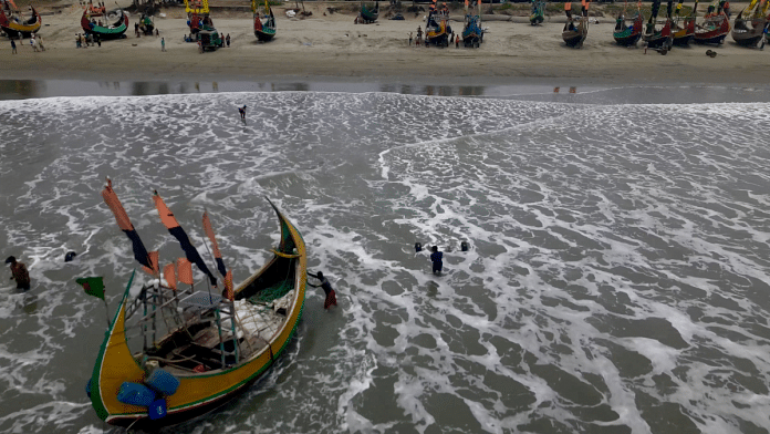 Fishermen portaging their boats to safer ground due to Cyclone Mocha, in Teknaf Marine Drive, Cox's Bazar, Bangladesh | Arjun Jain/Rohingya Refugee Response/Handout via REUTERS