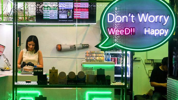 A woman works inside a cannabis shop, at Khaosan Road, one of the favourite tourist spots in Bangkok, Thailand | Reuters/Chalinee Thirasupa