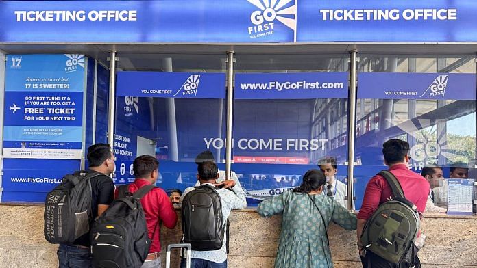 People wait to claim refunds after their flights were cancelled, from the Go First airline ticketing counter at the Chhatrapati Shivaji International Airport in Mumbai, on 3 May 2023 | Reuters