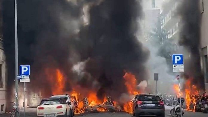 Cars in flames on Milan street on 11 May 2023