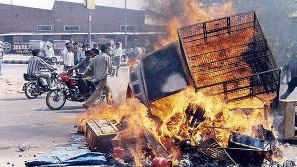 A vehicle is burnt during riots in Gujarat in 2002 | Photo: PTI