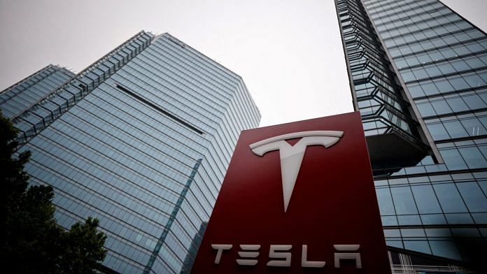 A Tesla logo is seen outside a showroom of the carmaker in Beijing, China | Reuters