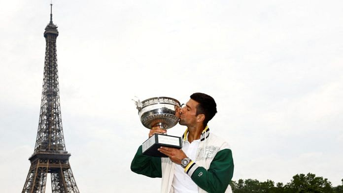 Serbia's Novak Djokovic kisses the trophy in front of the Eiffel Tower after winning the men's singles French Open title | Reuters