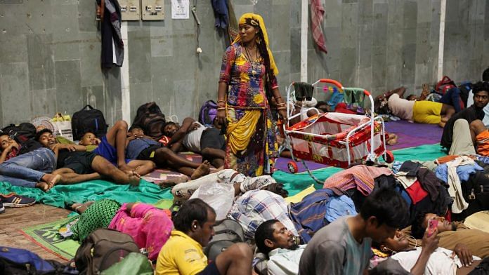 Laxmi Kumar pushes a cradle carrying her three year old son Arvind at a temporary shelter for people evacuated from Kandla port, before the arrival of cyclone Biparjoy, in Gandhidham, in the western state of Gujarat | Reuters