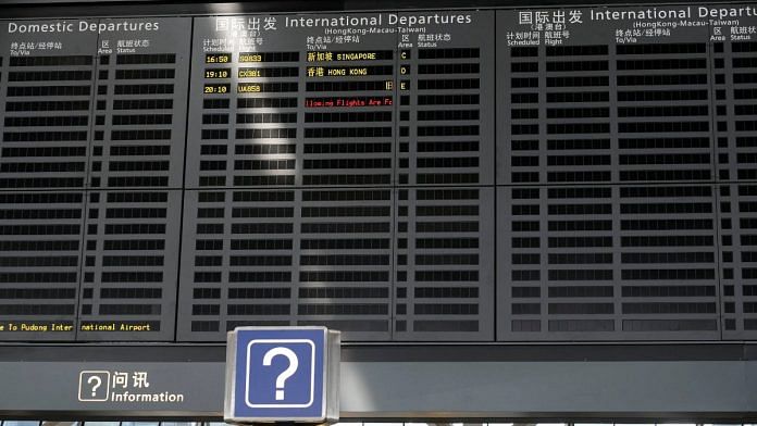 A display shows departure flight information, at Pudong International Airport, Shanghai, China | Reuters