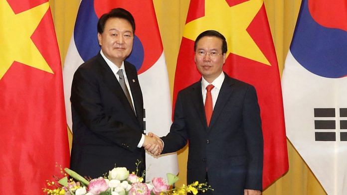 South Korea's President Yoon Suk Yeol shakes hands with Vietnam's President Vo Van Thuong during their meeting at the Presidential Palace in Hanoi, Vietnam | Reuters