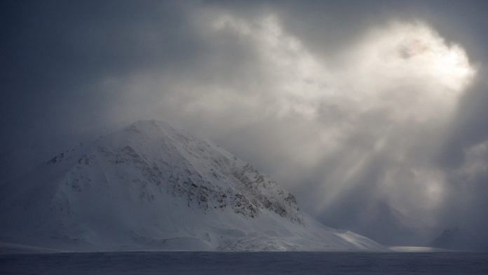 The sun shimmers through a cloud cover near Ny-Alesund, Svalbard, Norway | Reuters